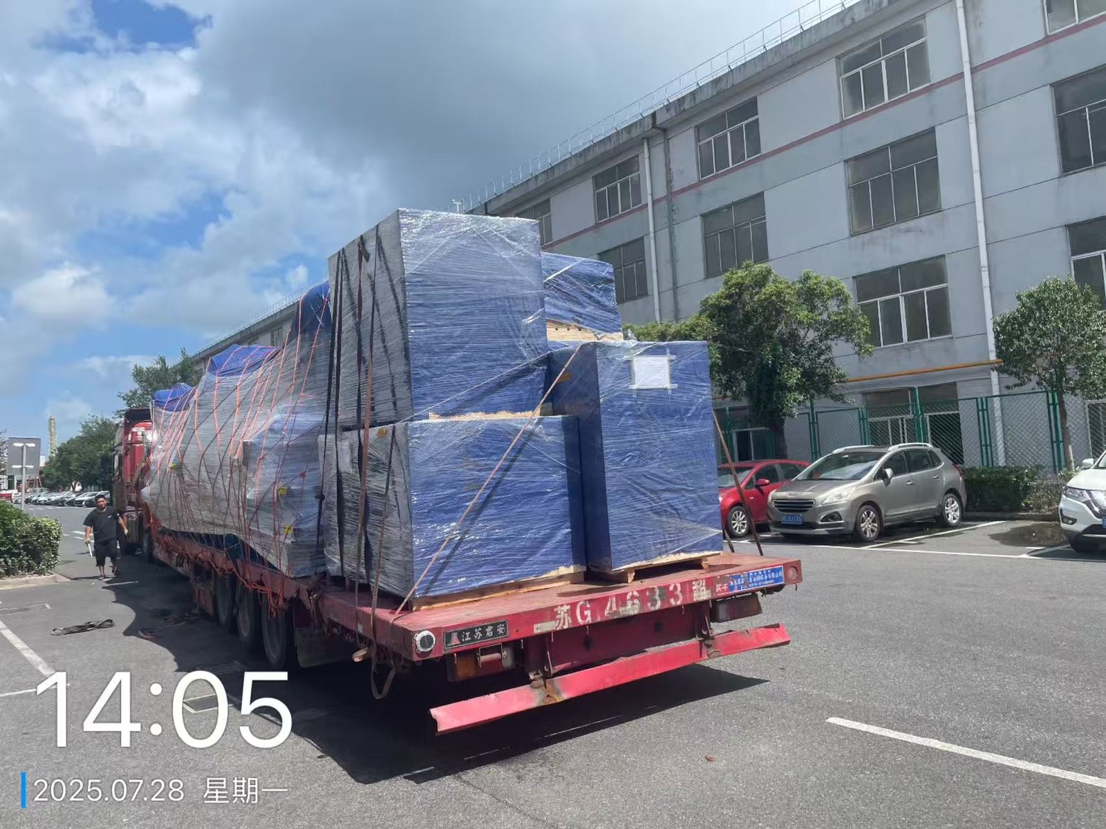 设备出口发运：满载平板车驶出厂区